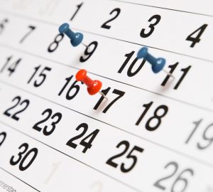 Closeup calendar page with drawing-pins